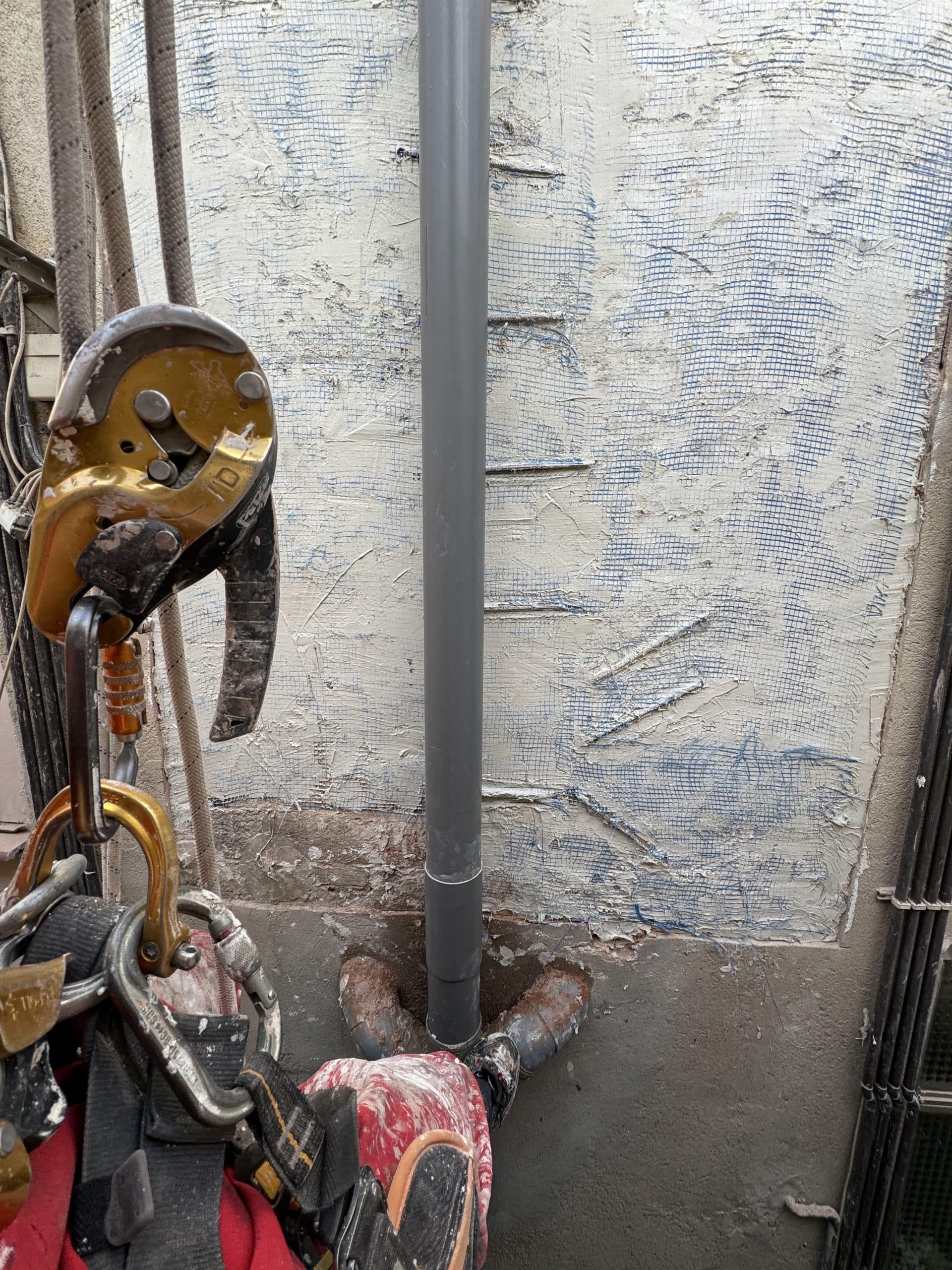 Detalle de tubería vertical junto a equipo de acceso por cuerdas